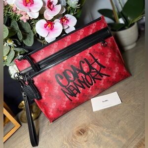 Coach Carryall Pouch in Red,featuring a black Horse and carriage.Graffiti design